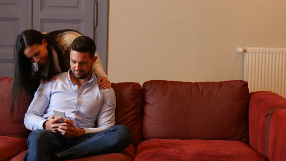 A young couple discussing content on a smartphone