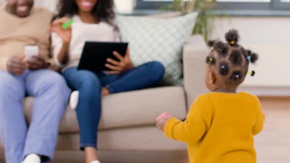 Happy African Family with Baby Daughter at Home