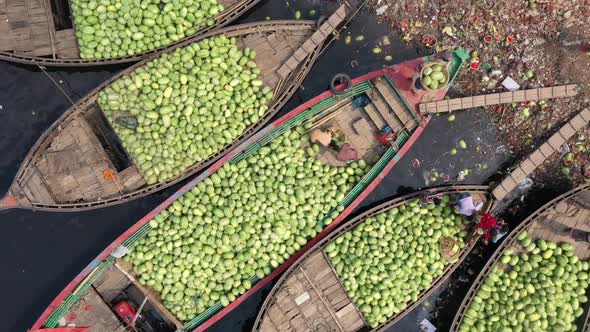 Aerial view of commercial boats with people unloading watermelons, Bangladesh.