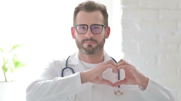 Portrait of Doctor Showing Heart Shape By Hands