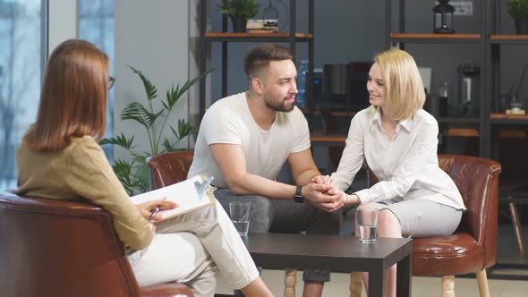 Smiling Couple Talking To Professional Psychologist and Solve Relationship Problems.