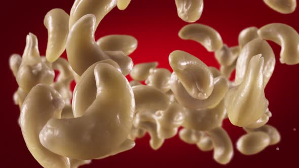 Flying of Cashews in Deep Red Background