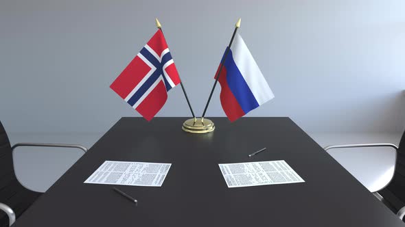 Flags of Norway and Russia and Papers on the Table