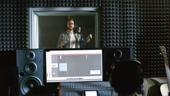 Energetic Man Recording Song in Studio