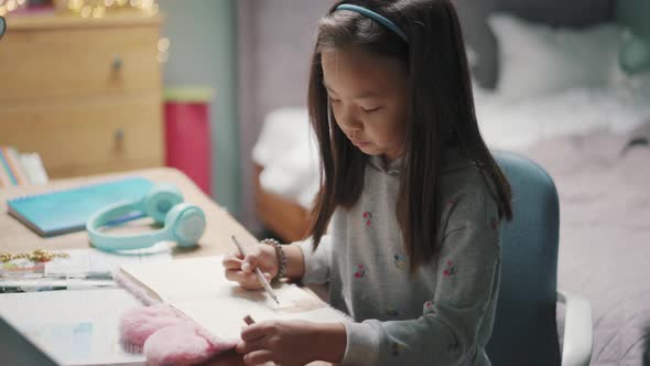 Asian girl painting at home