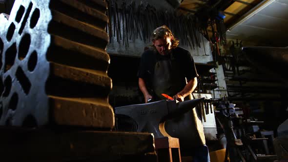 Blacksmith working on a iron rod