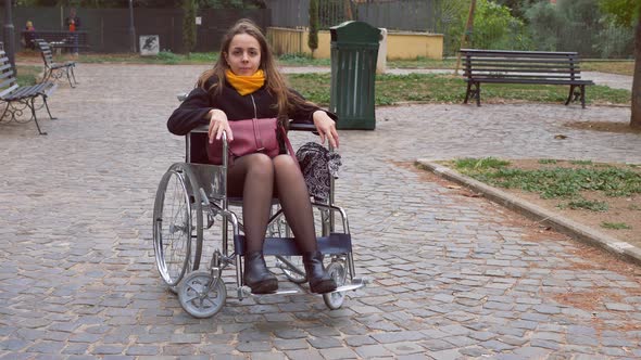 positivity, hope - young woman using wheelchair smiles confident at camera