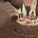 Two People Lighting the Candels on a Birthday Cake - VideoHive Item for Sale