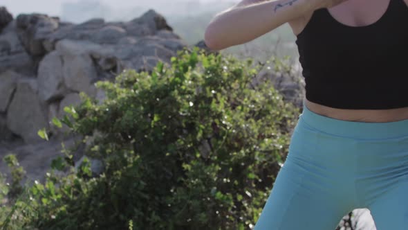 Young Woman Warming Up Her Body on Nature