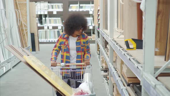 African American Woman with an Afro Hairstyle the Store Chooses Repair Tools
