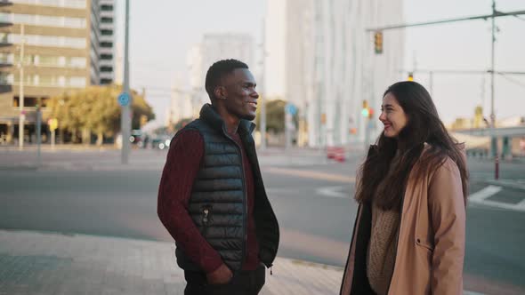 Delighted Diverse Friends Strolling in City and Chatting