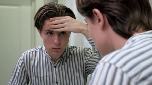 Young Guy Crushes Pimples in the Bathroom