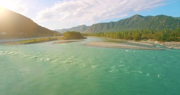 Low Altitude Flight Over Fresh Fast Mountain River with Rocks at Sunny Summer Morning.