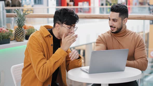 Young Excited Arab Guy Shows New Project on Laptop Shocked Man Reading Great News Applauds Support
