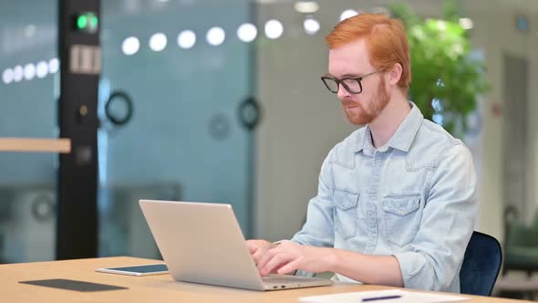 Loss Young Redhead Man Reacting to Failure on Laptop in Office