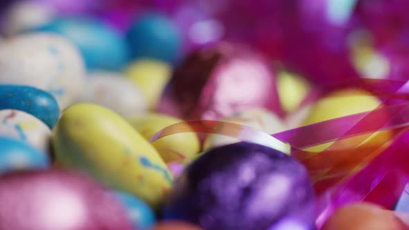 Rotating shot of colorful Easter candies on a bed of easter grass