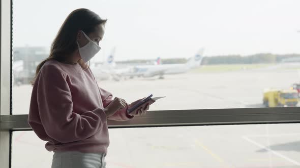 Lonely Girl Silhouette in Medical Mask in Airport Terminal at Plane Runaway Background of with