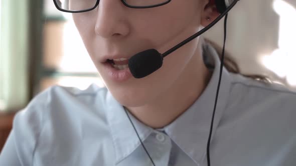 A Girl in Headphones with a Headset Conducts Consultations