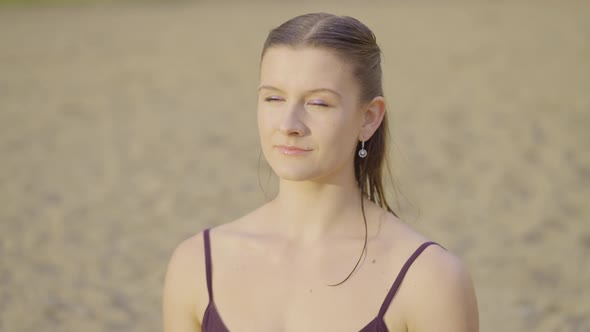 Attractive girl smiling at the beach