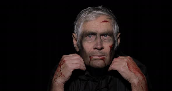 Old Executioner Halloween Makeup and Costume. Elderly Man with Blood on His Face