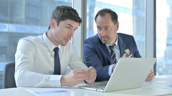 Business People Working on Laptop and Documents