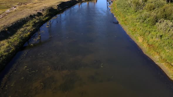 Old train trestle on a sunny day in north American Prairie. Aerial 4K Drone footage revealing scener