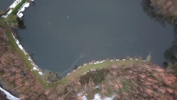 Aerial View of the Shore of a Big Forest Lake Showing the Clear Water the Sandy Beach and the Trees