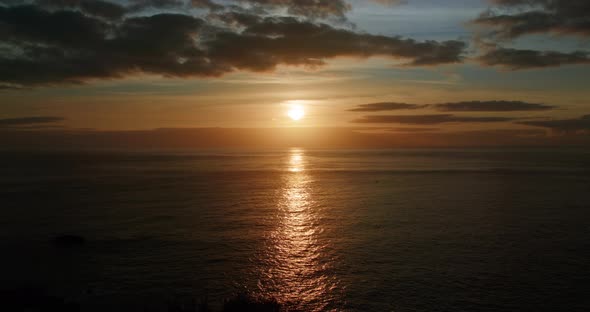 Red and Soft Light of the Sun Setting Beyond a Waterline