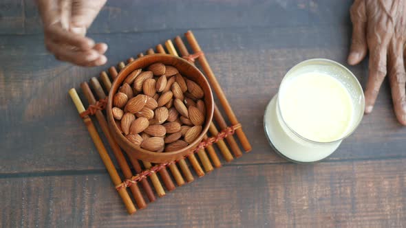 Top View of Senior Women Hand Holding a Bowl on Almond