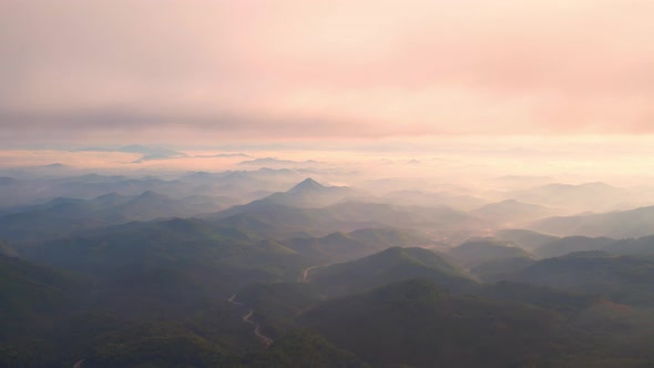 4K Flying through the clouds above mountain tops