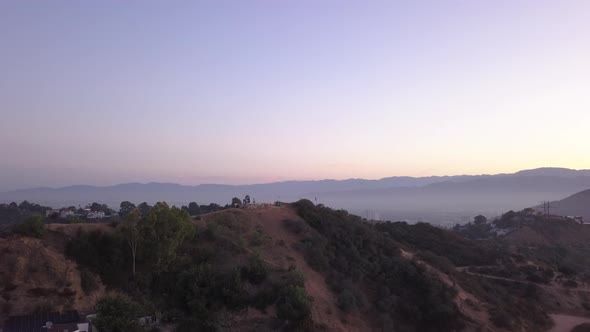 AERIAL Over Hollywood Hills at Sunrise with View on Hills and the Valley in Los Angeles View