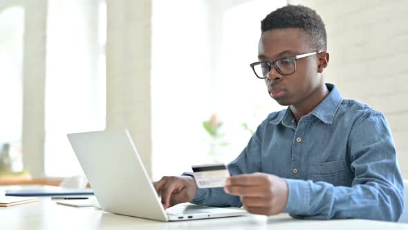 Successful Online Payment By African Man on Laptop