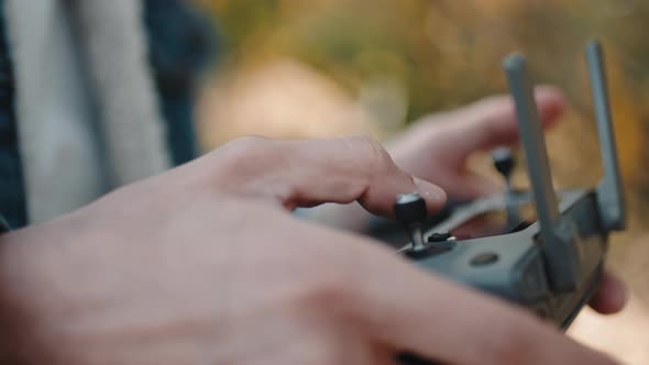 Hand of a Drone Operator Man While Pilot a Quadcopter Remote Controller