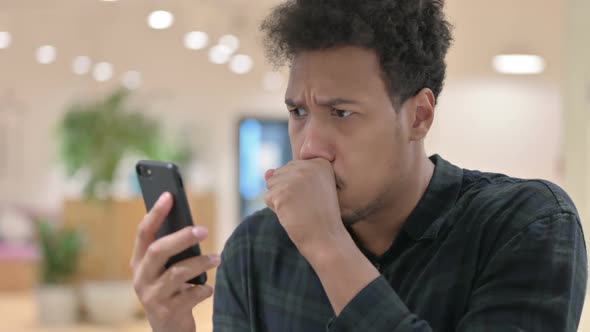 African American Man Loss on Smartphone