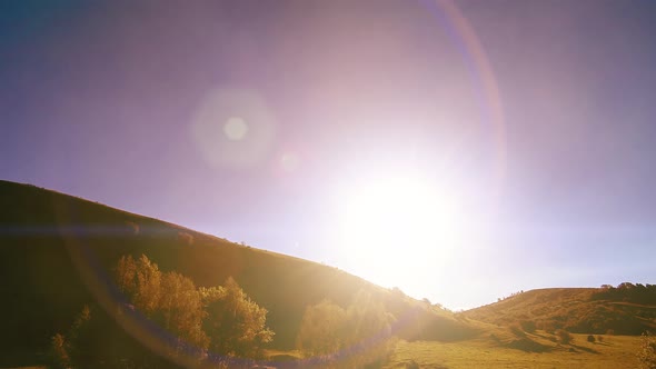 Mountain Meadow Timelapse at the Summer. Clouds, Trees, Green Grass and Sun Rays Movement