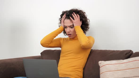 Shocked Businesswoman Looks at Laptop Screen Display Worried of Problem at Home