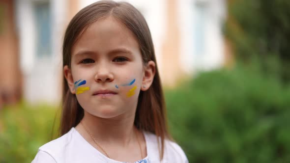 Closeup Ukrainian Girl with Serious Facial Expression Turning Looking at Camera in Slow Motion