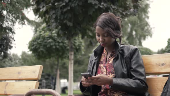 Handsome Trendy African American Black Woman Recording Voice Message on Cell Phone That He Is