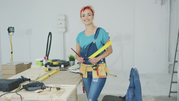 Female Carpenter Standing at Workbench