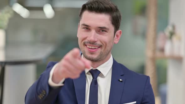 Assertive Young Businessman with Pointing at the Camera