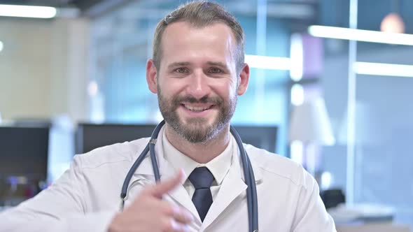 Portrait of Cheerful Young Doctor Showing Thumbs Up