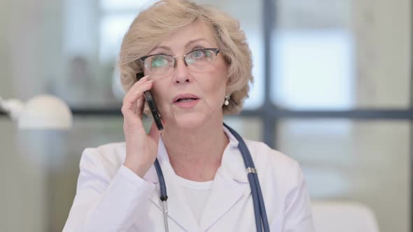 Old Female Doctor Talking on Phone