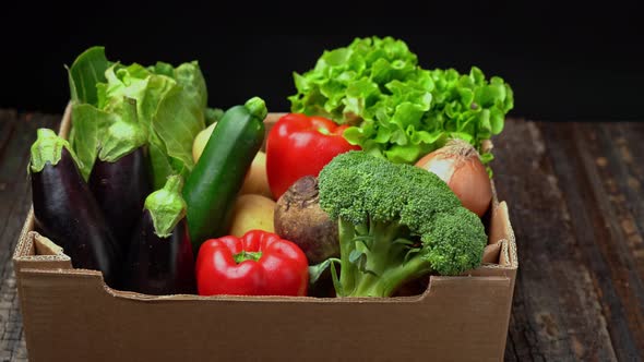 A Box Full of Fresh Vegetables on a Dark Background Wooden Vintage Table