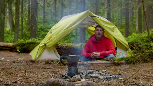 A Tourist in a Tent in the Background