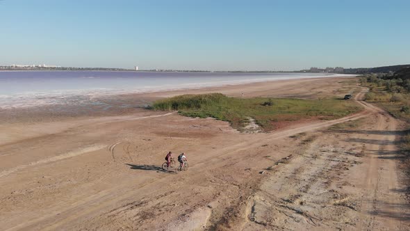 Travellers ride bikes around Kuyalnik estuary, aerial drone view