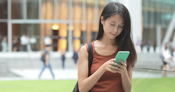 Woman use of mobile phone at outdoor street 