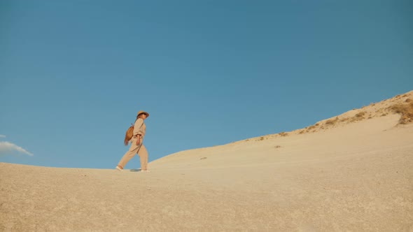 A Woman Traveler Climbs the Sandstone Mountain