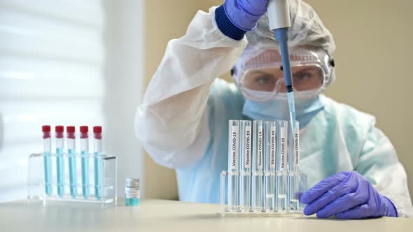 Professional Female Scientist in Protective Eyeglasses and Mask Making Experiment with Reagents in