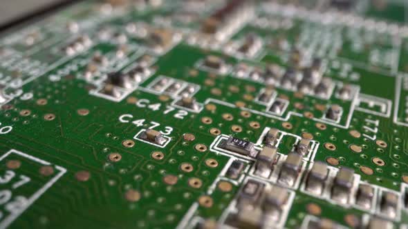 Extreme close-up of green Printed Circuit Board Electronics shot with dolly