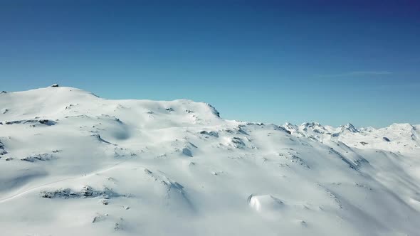 Aerial drone view of snow covered mountains in the winter.